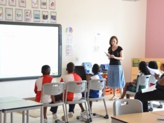 A teacher and pupils in a classroom