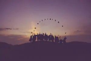 Silhouette of people standing on a hill