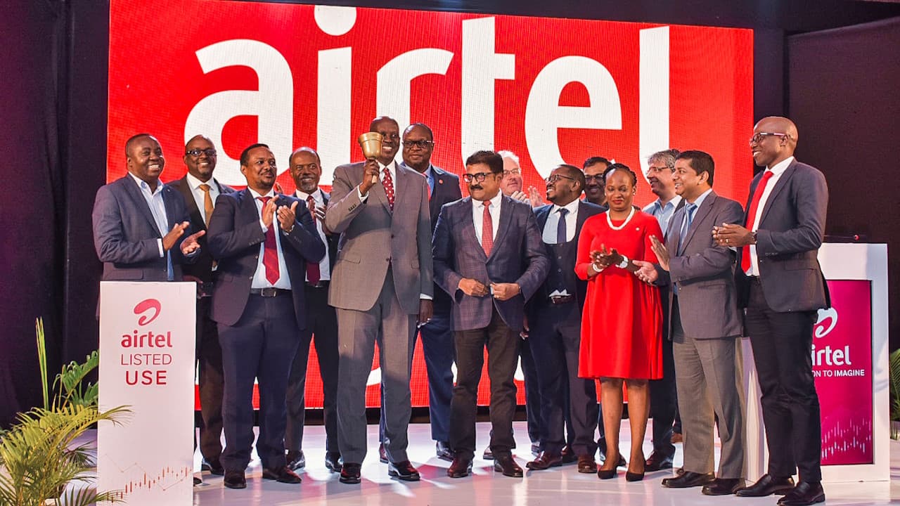 Airtel Uganda's board chair Hannington Karuhanga rings the opening bell with other officials and guests during the company's listing on the Uganda Securities Exchange in Kampala on Tuesday