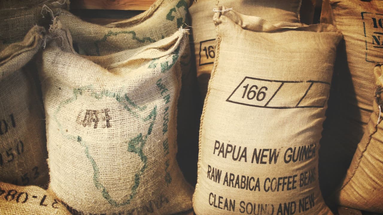 Jute bags containing coffee beans in a café storage area