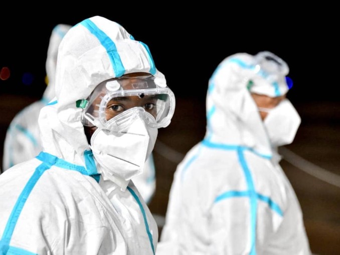 Two masked health workers