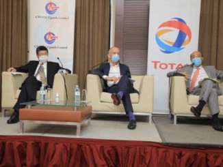 Three male executives at a press conference
