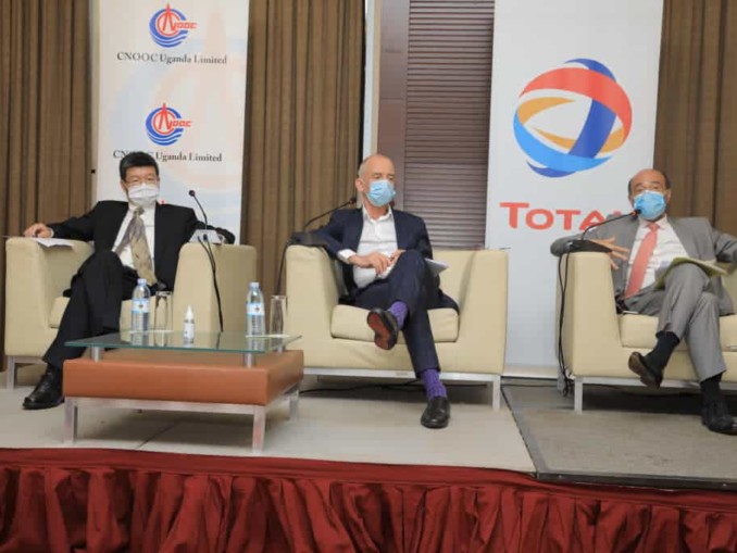 Three male executives at a press conference