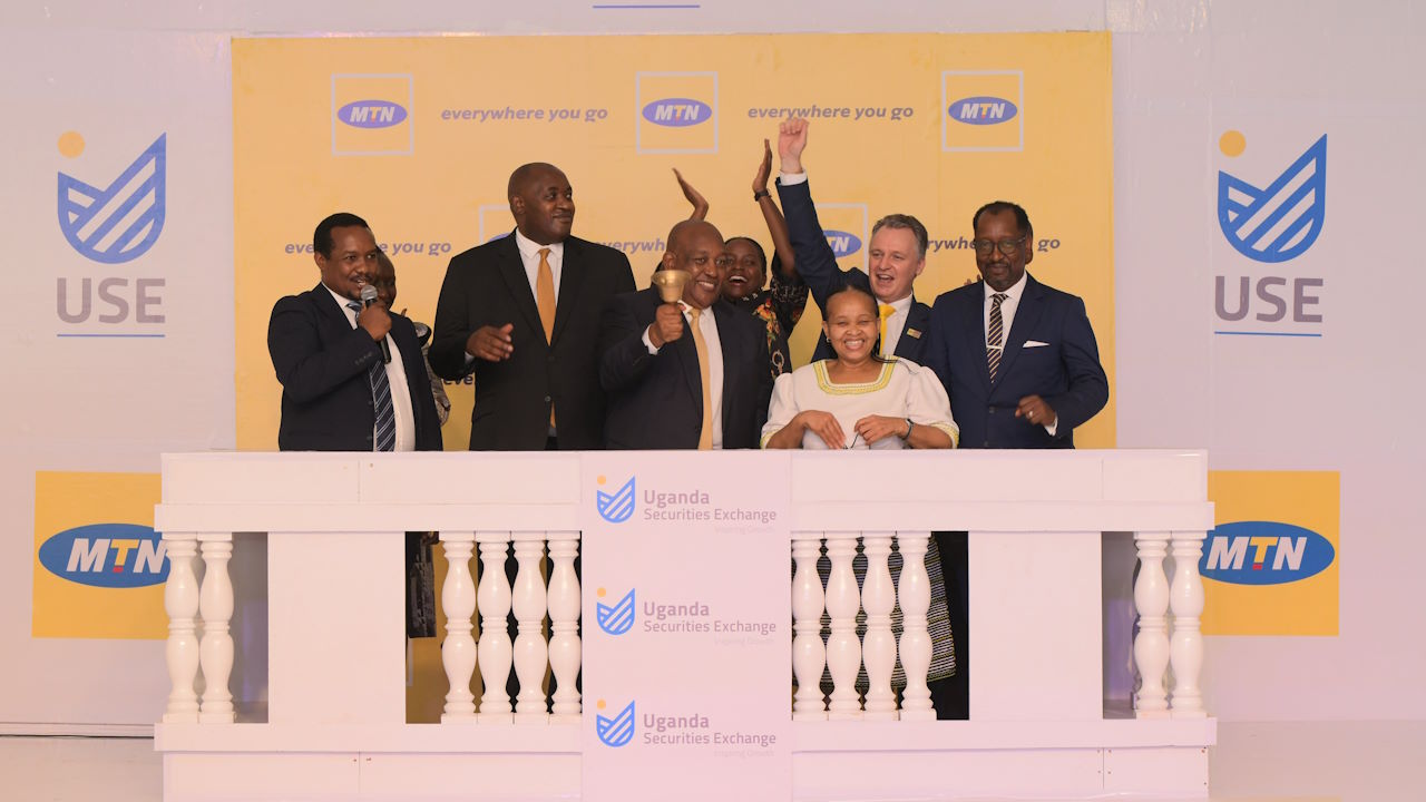 MTN Uganda non-executive director Charles Mbire rings the bell to mark the telecoms company's listing on the Uganda Securities Exchange, December 2021