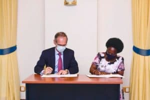 Uganda's energy minister, Mary Goretti Kituttu and Total's Nicolas Terraz signing the oil pipeline host government agreement
