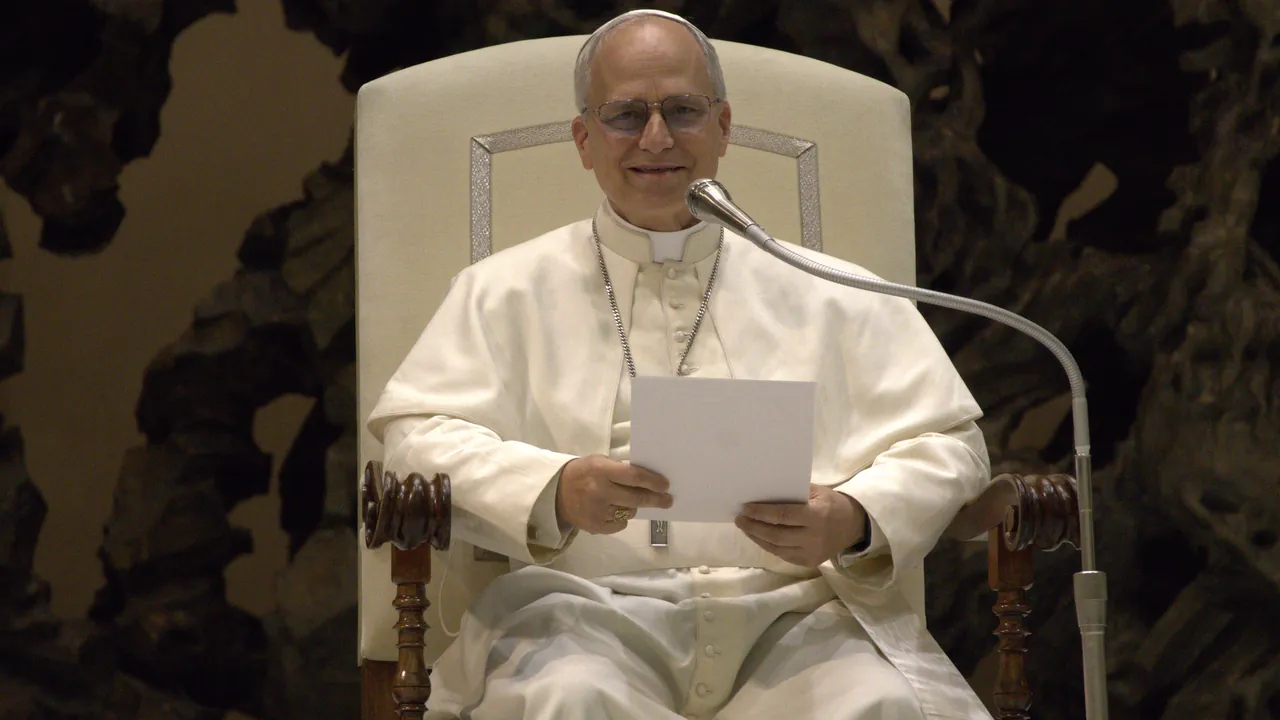 Pope Leo XIV | Uganda Business News A man wearing a white cassock and zucchetto sits in a high-backed chair while holding a sheet of paper.