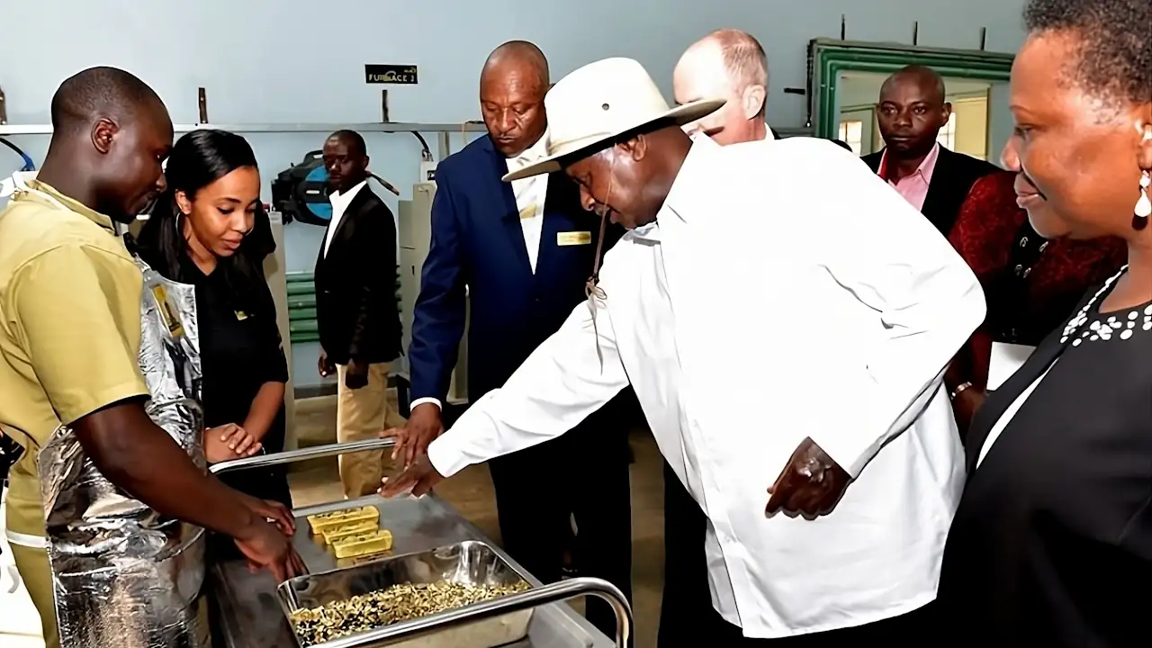Ugandan President Yoweri Museveni, Irene Muloni, minister for energy and minerals development (right), AGR Business Development Manager Alphonse Katerebe (centre) and two unidentified people stand near gold flakes and ingots at the African Gold Refinery in Entebbe on 20 February 2017. Alain Goetz, the Belgian owner of the refinery, stands next to Mr Museveni, and is partially obscured from view. The refinery was officially launched on 20 February 2017, and is Uganda's first official gold refinery. Uganda's locally mined gold is negligible, but the country is a transit point for gold exports from the neighbouring Democratic Republic of Congo, which has large reserves, and Tanzania, one of Africa's largest gold producers.