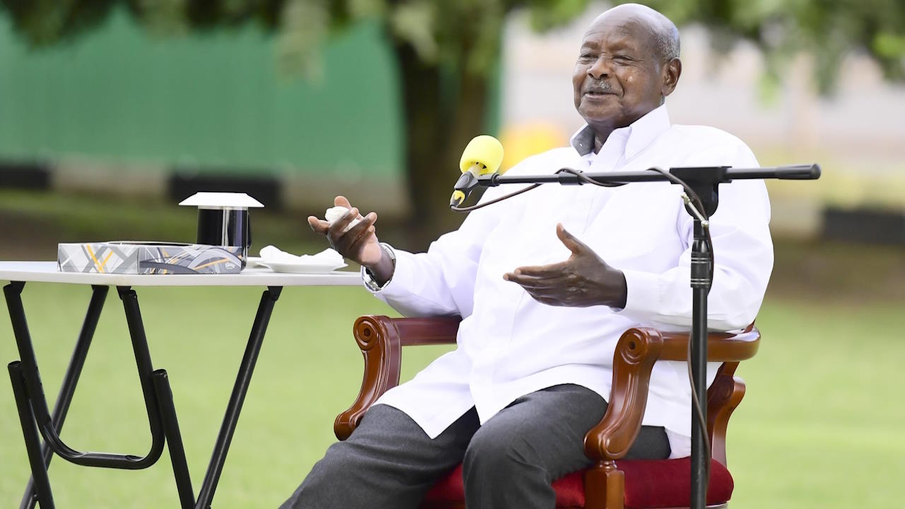 Uganda's president Yoweri Museveni, gestures, while smiling, and seated, in an October 2023 photo