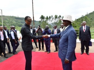 Presidents Yoweri Museveni and Paul Kagame shake hands