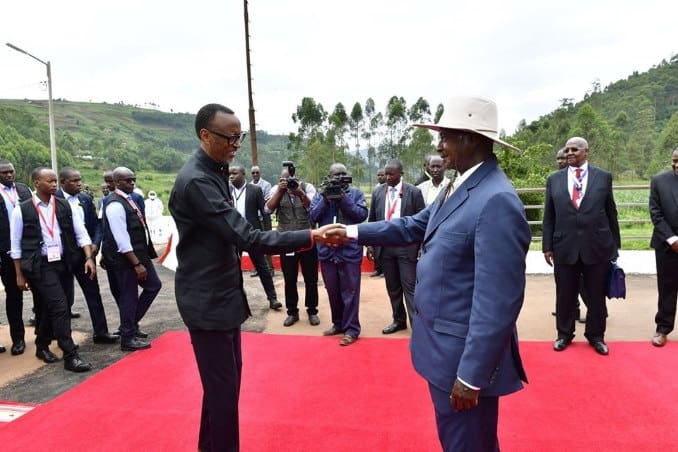 Presidents Yoweri Museveni and Paul Kagame shake hands
