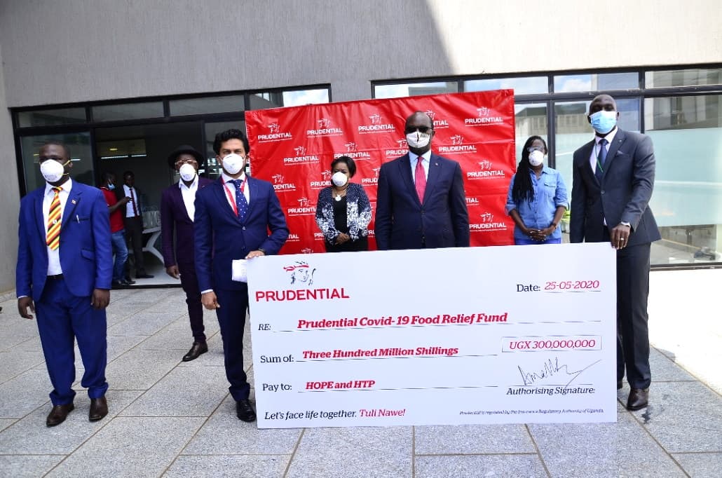 Prudential Uganda executives pose with a dummy cheque