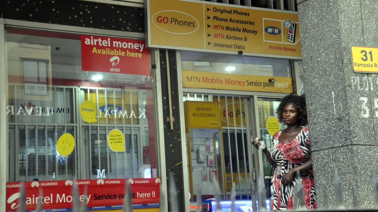 The exterior of a shop offering mobile money services in Kampala