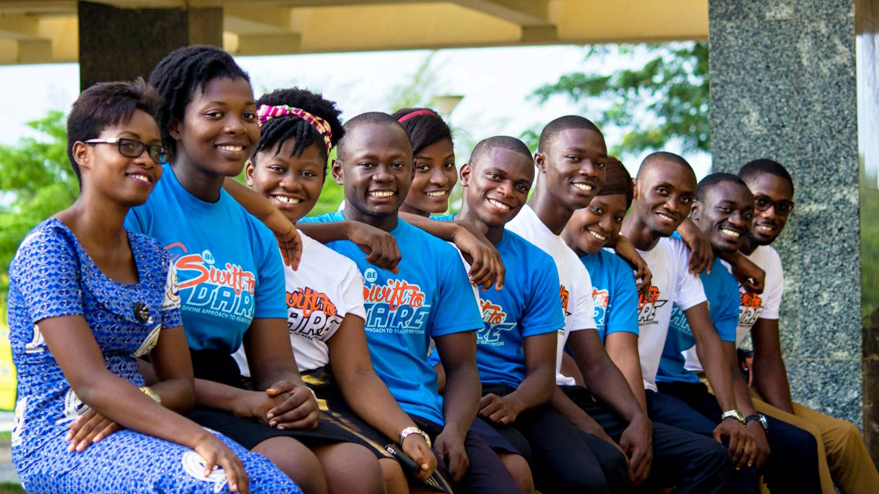 Eleven teenage students in Ghana, all seated