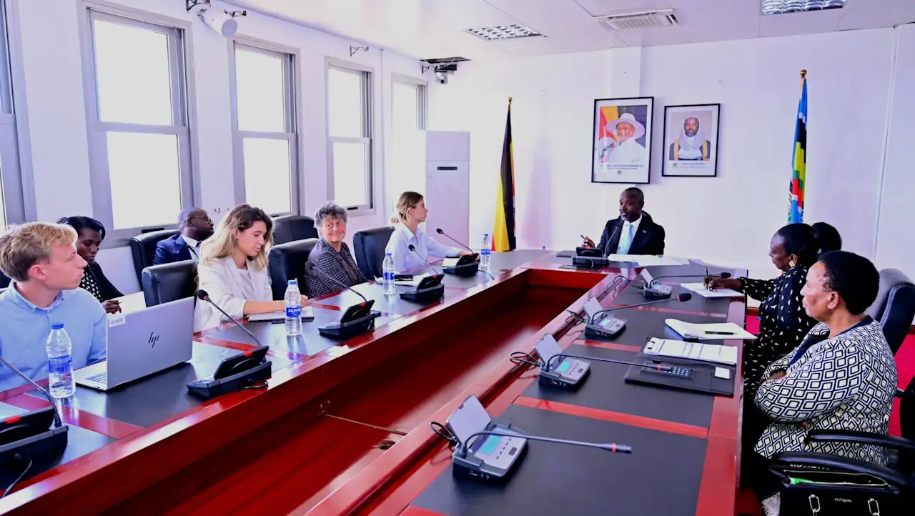 Thomas Tayebwa chairs a meeting at the head of a boardroom table; to his side sit MEPs Anna Strolenberg, nearest him, and Tineke Strik, with Ugandan officials opposite