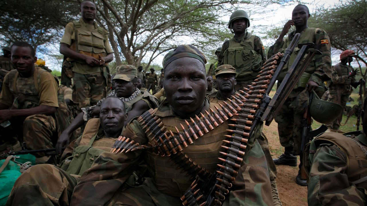 Ugandan soldiers serving with the African Union Mission in Somalia (AMISOM), listens while Contingent Commander for Uganda, Brigadier Paul Lokech (not seen) briefs members of 09 Battalion before an advance on the town of Afgoye to the west of the Somali capital Mogadishu. AMISOM and Somali National Army (SNA) troops swept through Afgoye on the morning of the 25th May 2012 without a shot being fired, liberating the area and its population - including 400,000 internally displaced people - from the control of the Al-Qaeda-affiliated extremist group Al Shabaab.