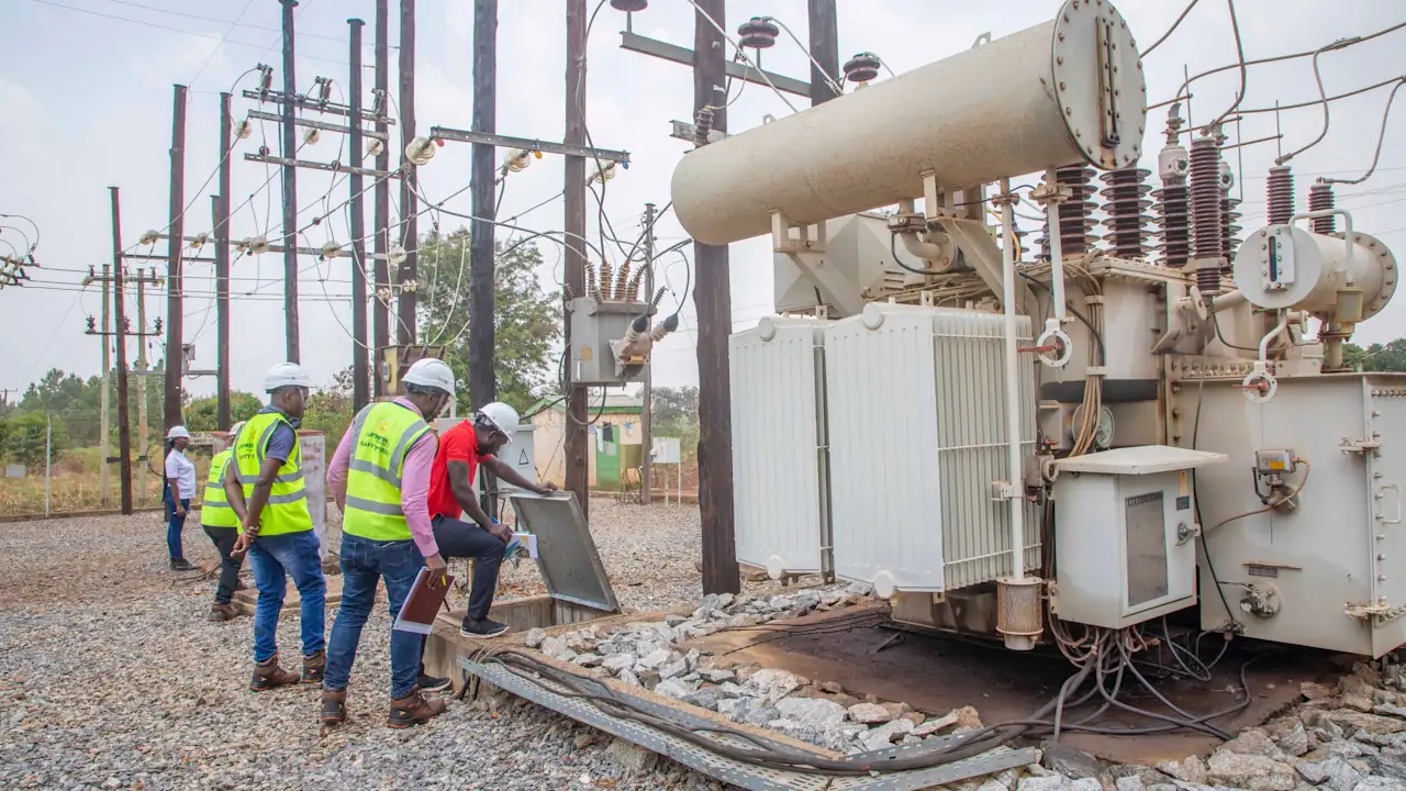 Umeme Limited employees and officials from the Electricity Regulatory Authority of Uganda inspect a power station.