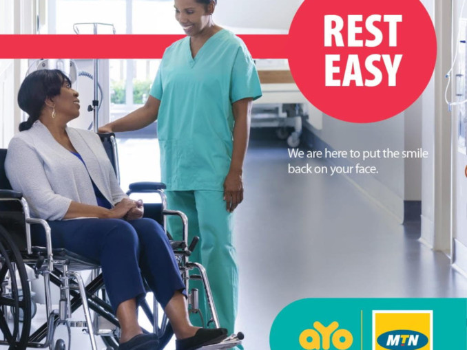 A female nurse talks to a woman in a wheelchair